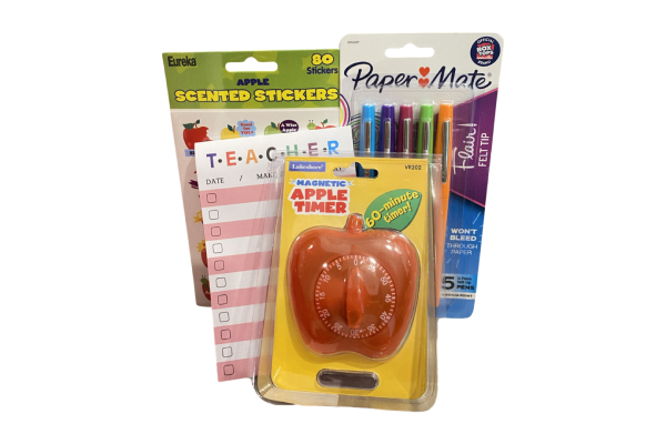 A group of items that include markers, stickers and an apple.