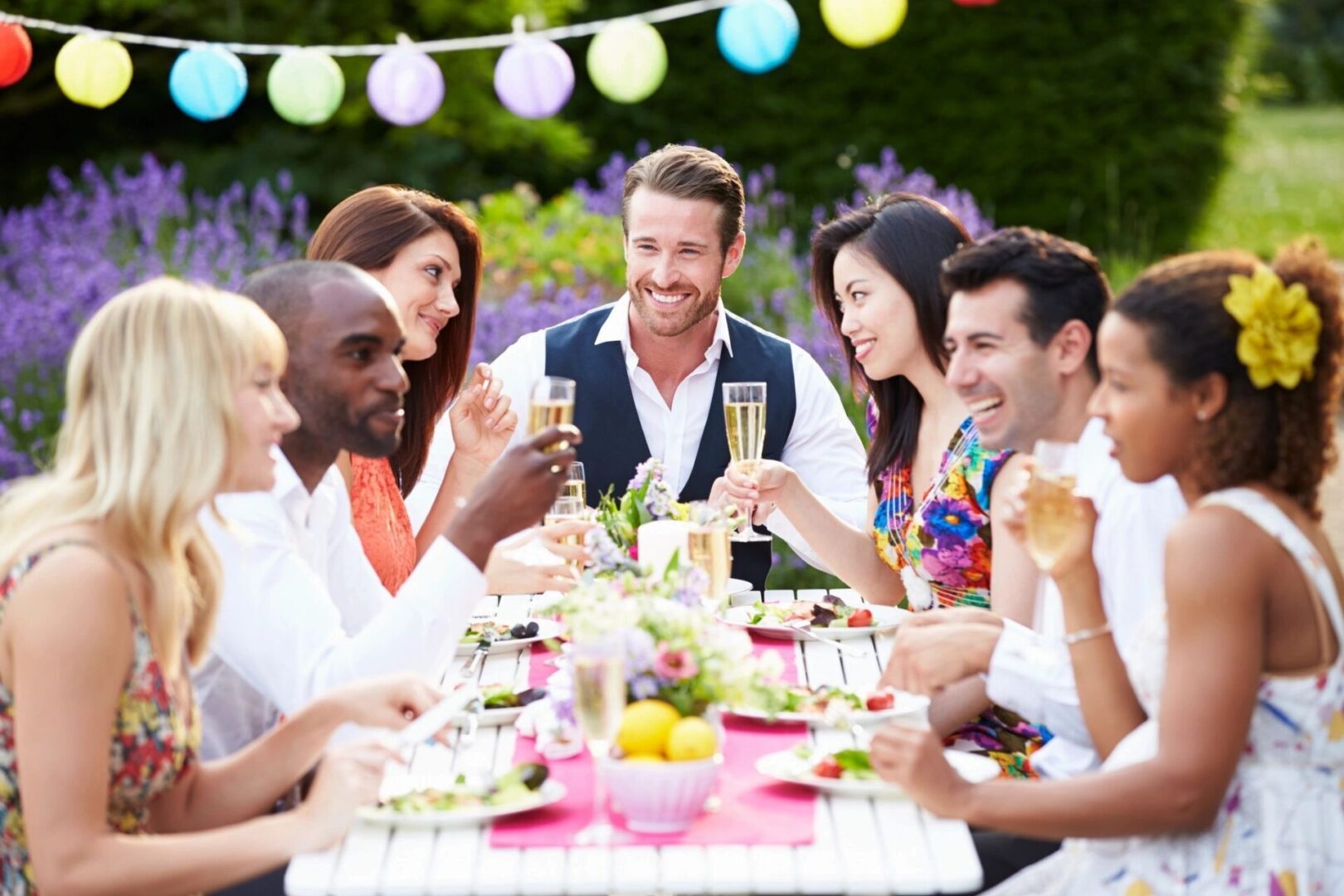 A group of people sitting at a table with food.